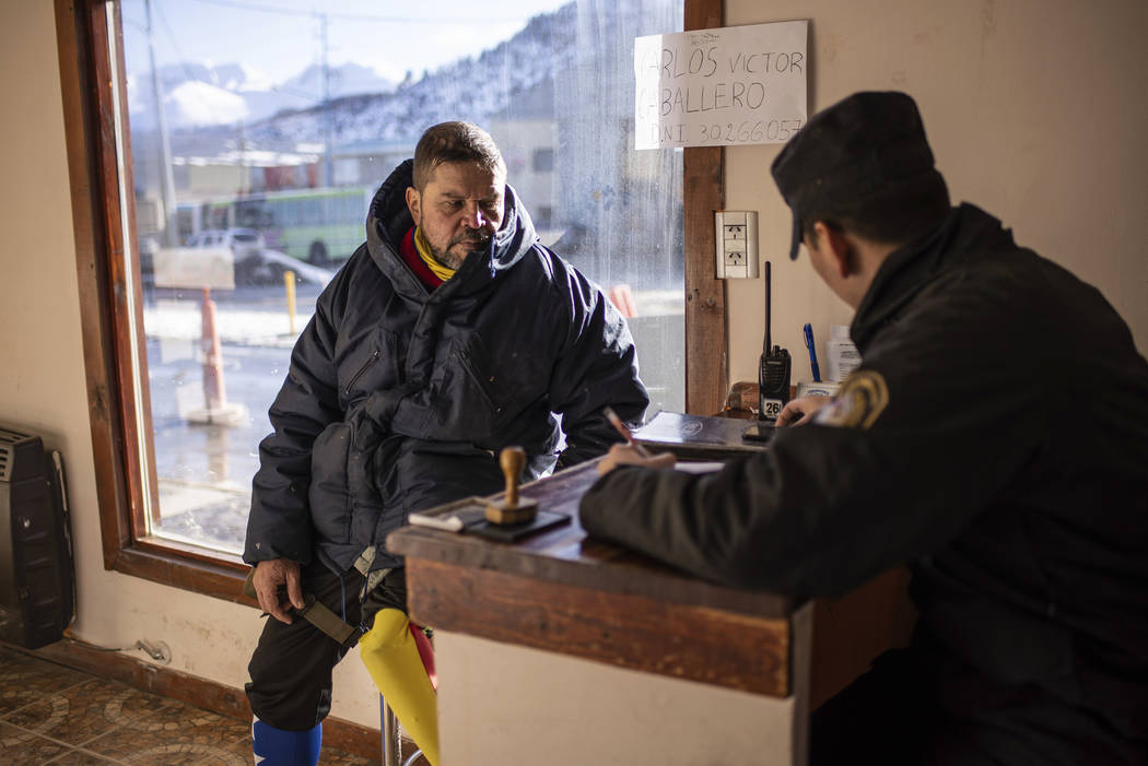 Venezuelan Yeslie Aranda registers his arrival at a police police station in Ushuaia, Argentina ...