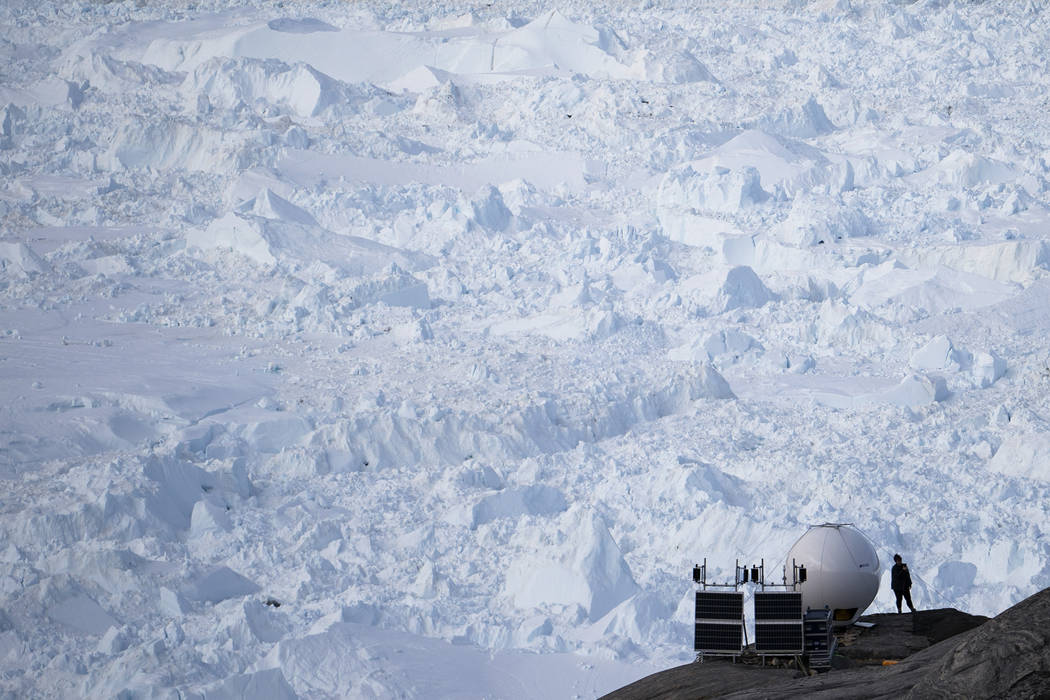 In this Aug. 16, 2019, photo, a woman stands next to an antenna at an NYU base camp at the Helh ...