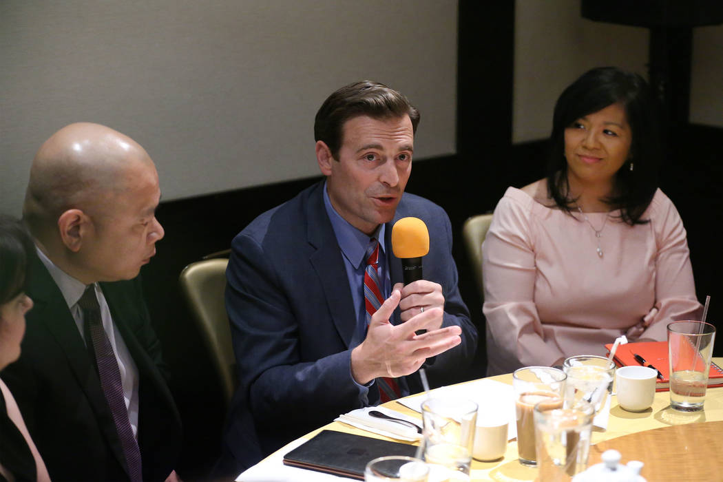 Former Nevada Attorney General Adam Laxalt, center, with Sonny Vinuya, left, president for the ...