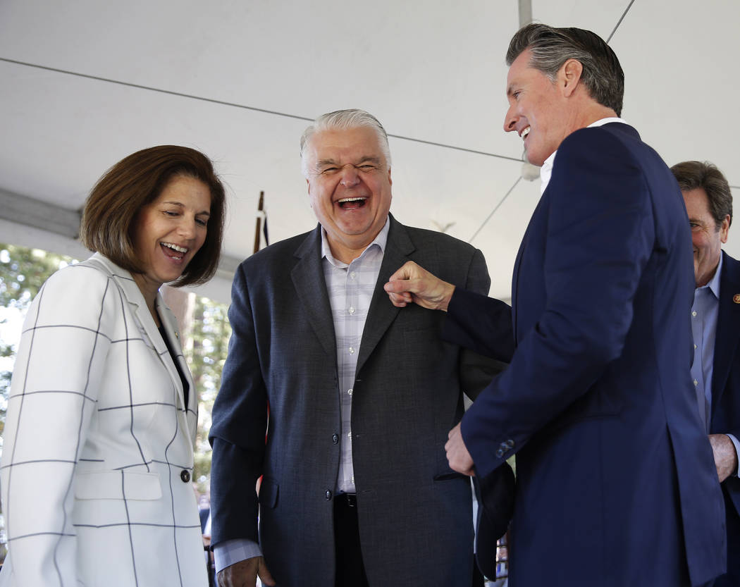 California Gov. Gavin Newsom, right, has a light-hearted moment with Nevada Gov. Steve Sisolak, ...