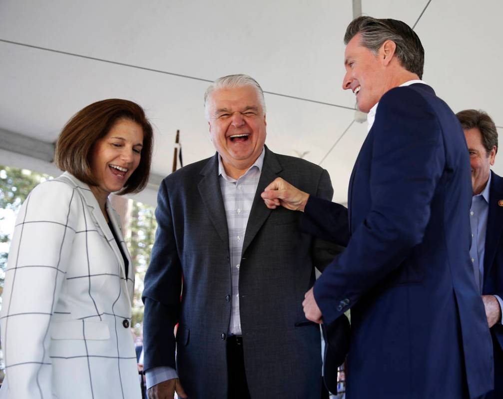 California Gov. Gavin Newsom, right, has a light-hearted moment with Nevada Gov. Steve Sisolak, ...