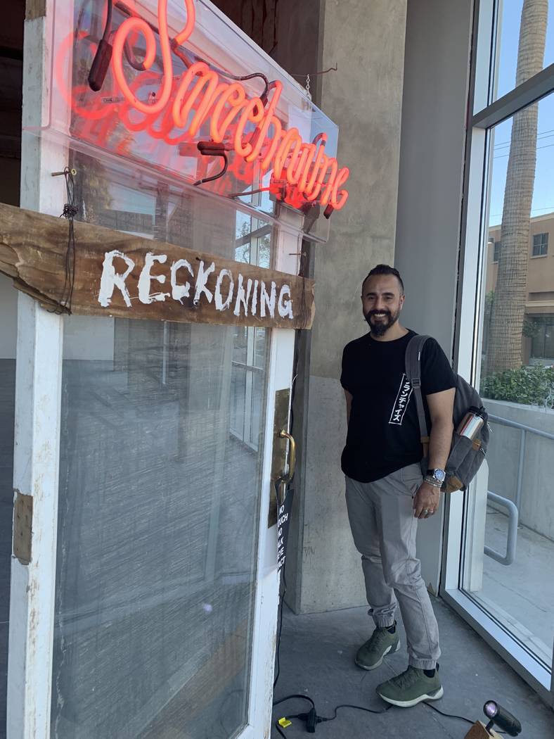 Ali Fathollahi stands next to his exhibit in the downtown area that will be available for viewi ...
