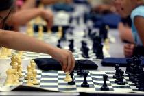 Groups of children play chess at the Wengert Elementary School during a Clark County Parks and ...