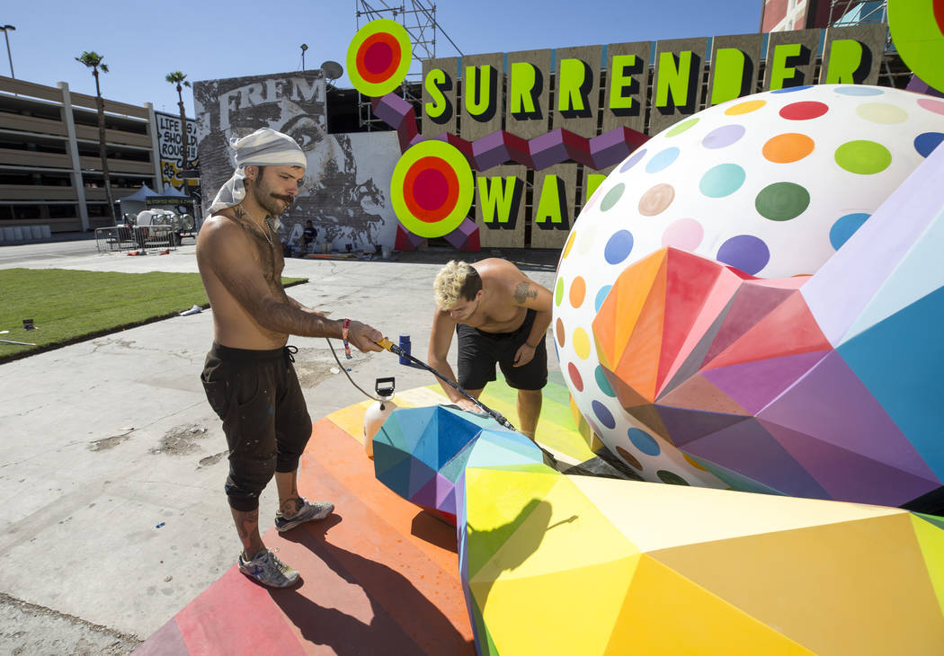 Pablo Hattori, left, and Marcos Martinez, assistants to Spanish street artist Okuda San Miguel, ...