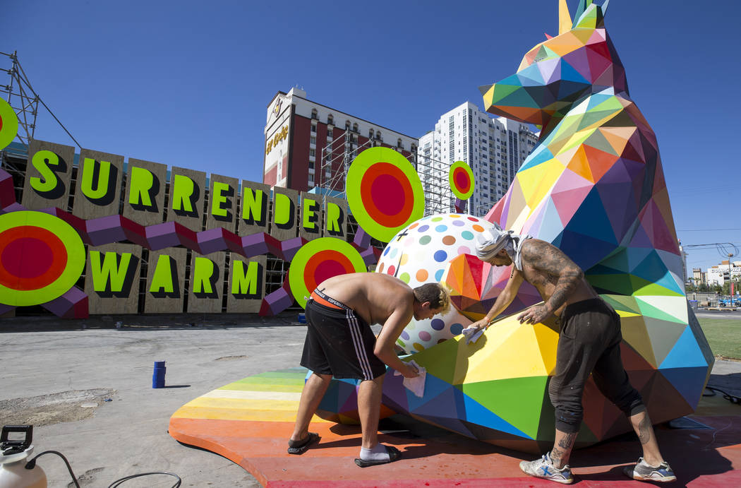 Marcos Martinez, left, and Pablo Hattori, assistants to Spanish street artist Okuda San Miguel, ...