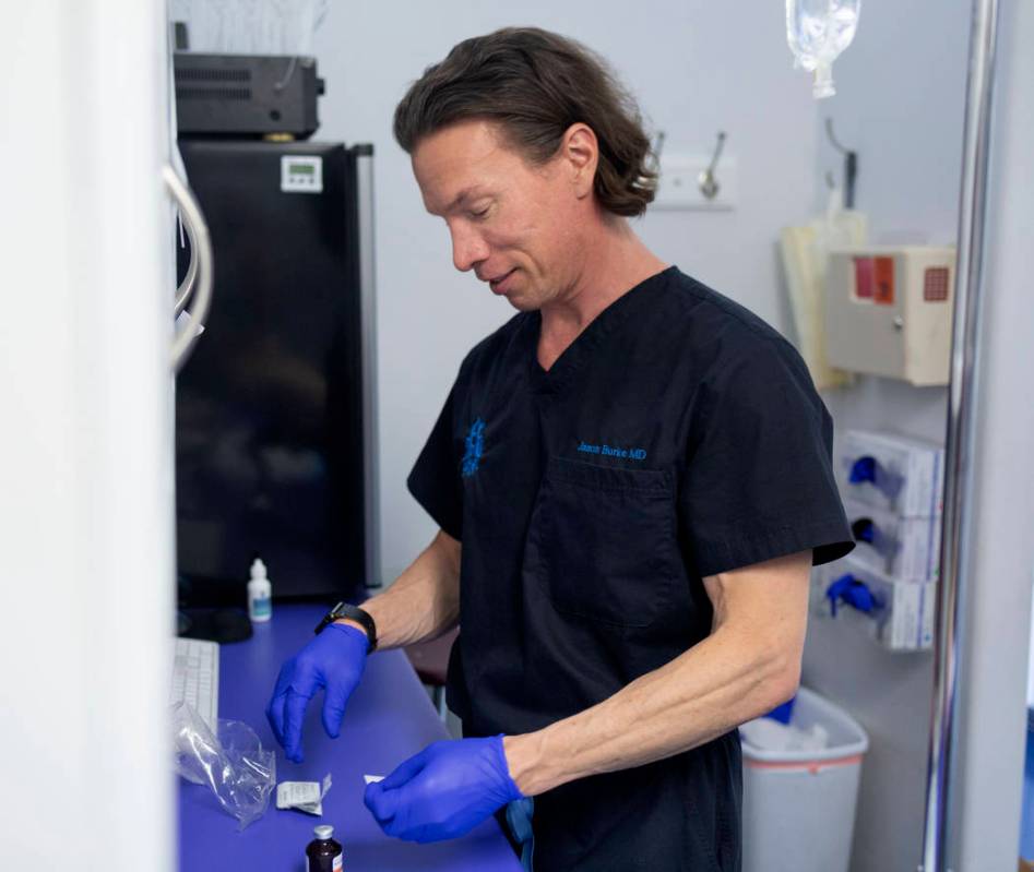 Dr. Jason Burke, founder of pioneering IV-therapy business Hangover Heaven, prepares IV fluids ...