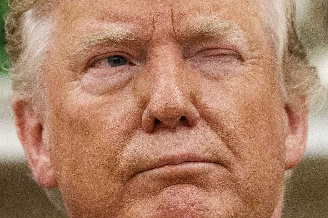 President Donald Trump winks at a journalist while speaking during a meeting with Romanian Pres ...