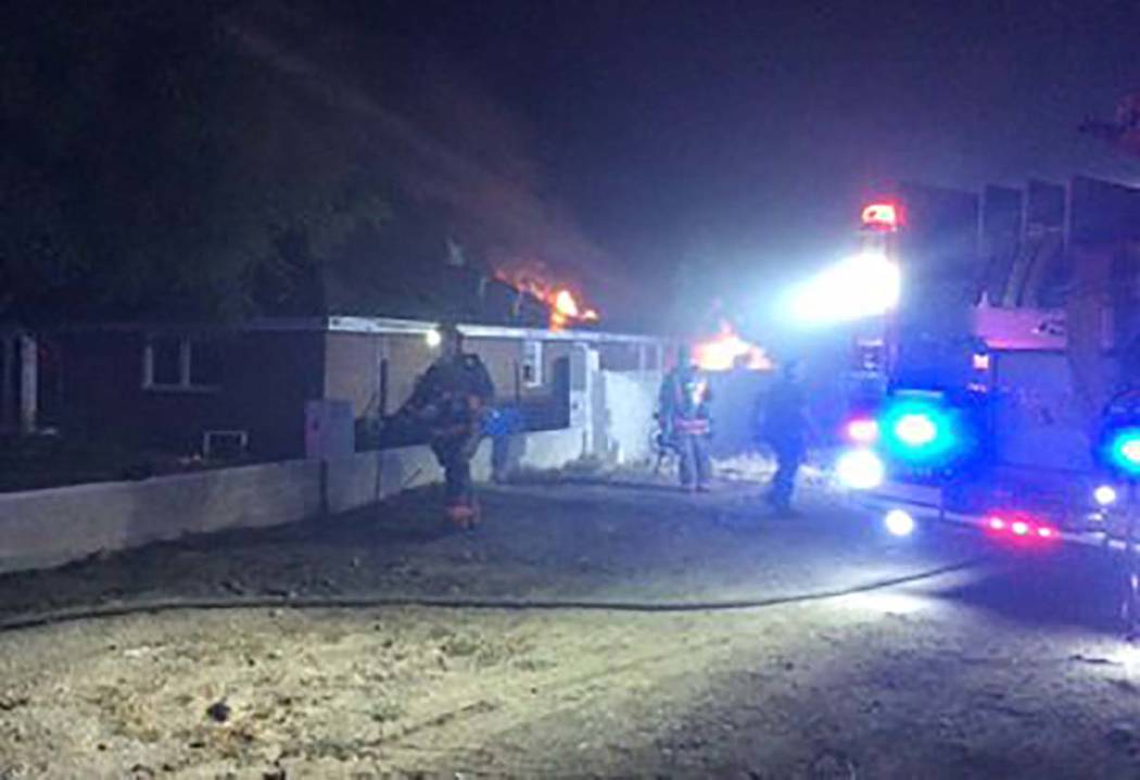 Las Vegas firefighters at the scene of a house fire at 3011 Alta Drive on Wednesday, Aug. 21, 2 ...