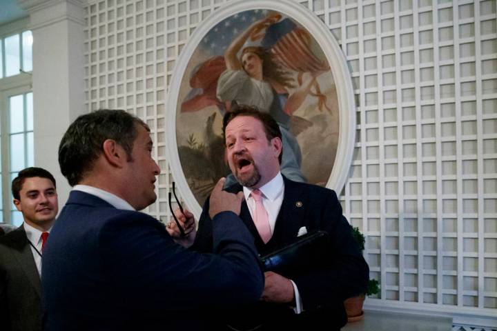 Radio host Sebastian Gorka, right, speaks with Playboy's Brian Karem, center, after President D ...