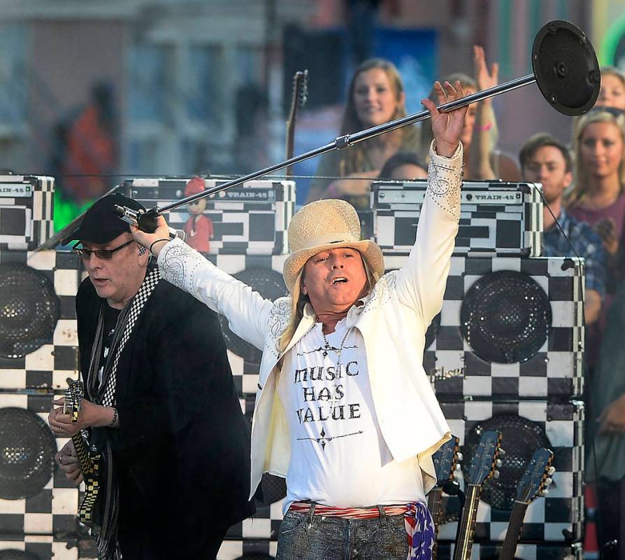 Rick Nielsen, left, and Robin Zander of Cheap Trick perform on an outdoor stage during the CMT ...