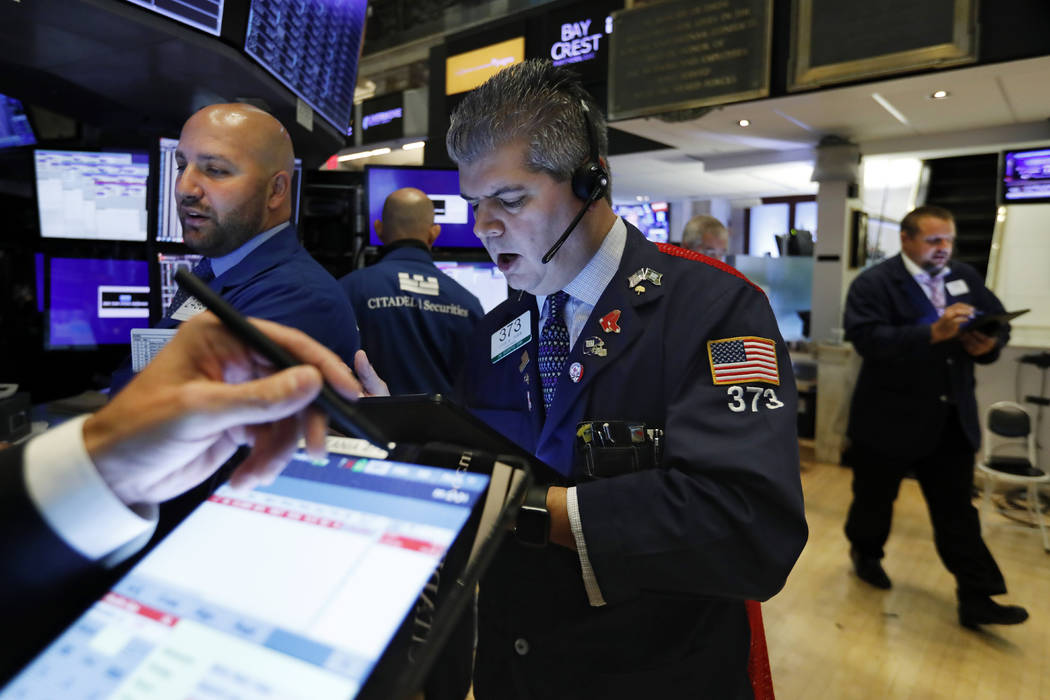 Trader John Panin, center, works on the floor of the New York Stock Exchange, Wednesday, Aug. 2 ...