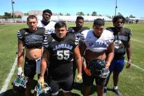 Desert Pines High School defensive linemen Gabriel Lopez, front left, Blaze Homalon (55), Darne ...