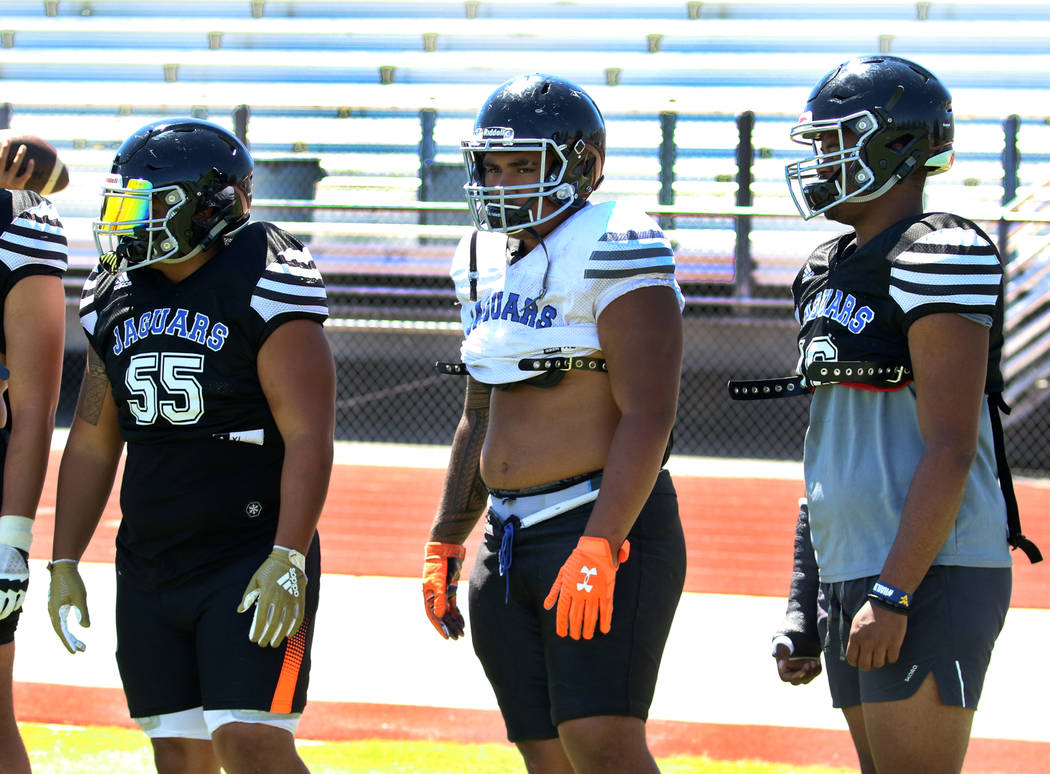 Desert Pines High School defensive linemen Blaze Homalon, left, and Fatafehi Vailea, and Jonath ...