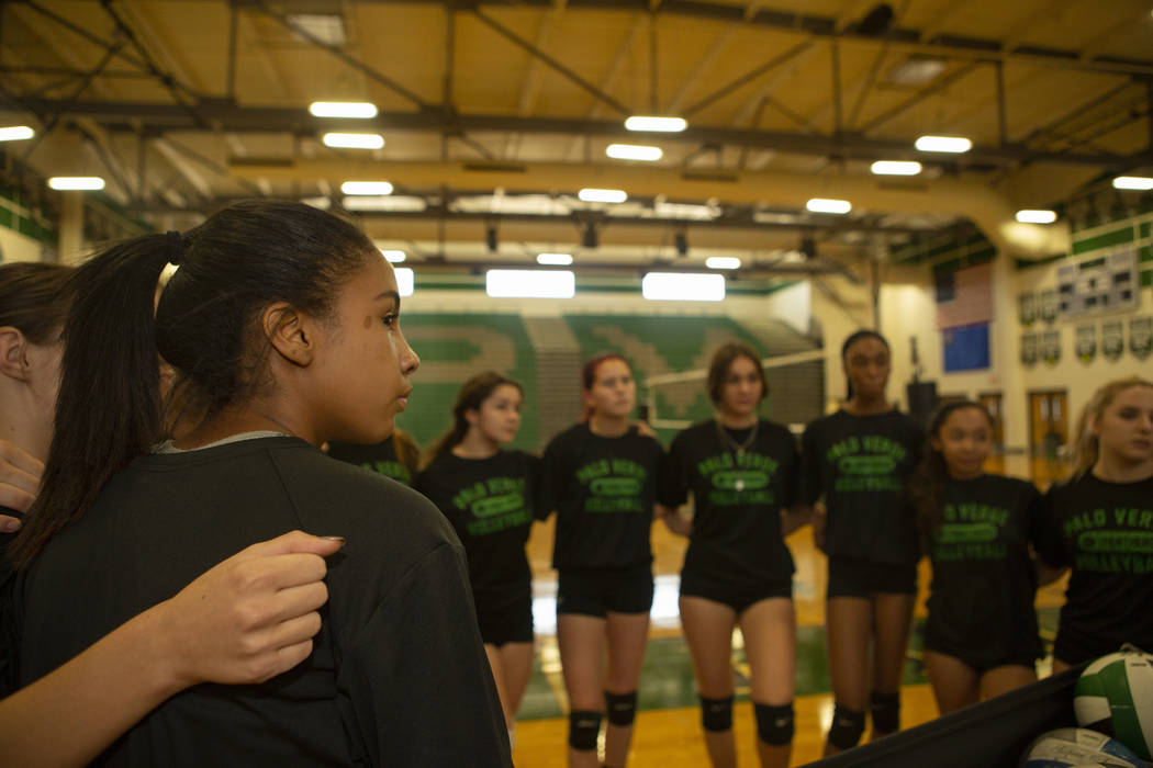 Danny Robinson, 14, freshman, embraces with other junior varsity teammates during practice at P ...