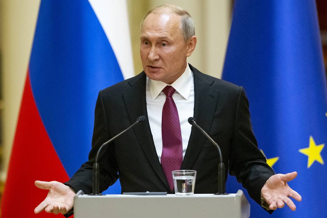 Russian President Vladimir Putin speaks during a news conference after his meeting with Preside ...