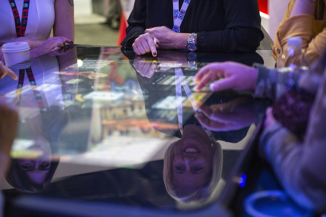 Attendees play Pac-Man, a skill-based game, at Gamblit booth at the 18th annual Global Gaming E ...