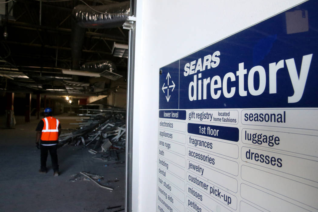 Workers recycle building material inside the former Sears store is shown at the Boulevard Mall ...