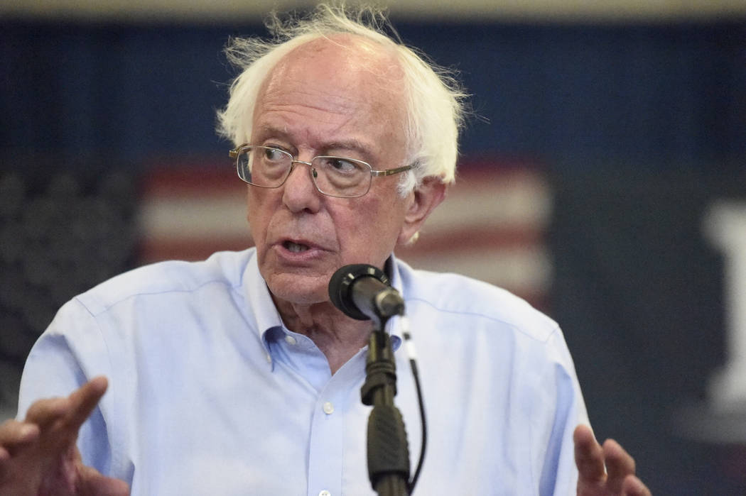 Democratic presidential hopeful Bernie Sanders looks on as panel members discuss his criminal j ...