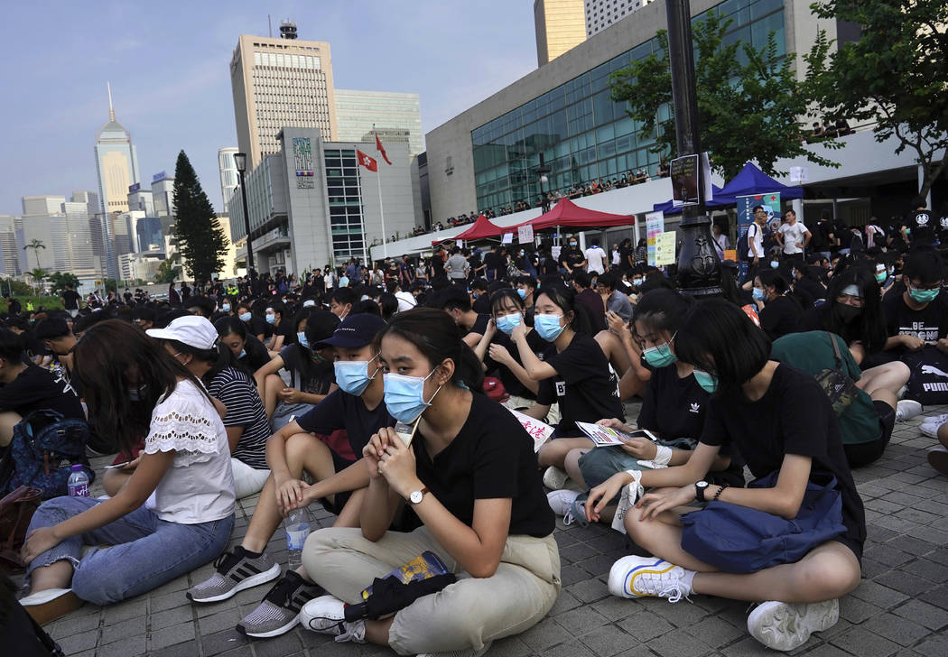 Students and others gather during a demonstration at Edinburgh Place in Hong Kong, Thursday, Au ...