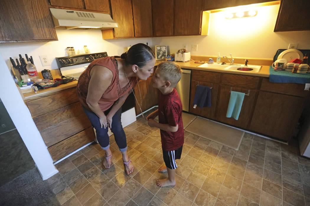 Misty Dotson kisses her son at their home Tuesday, Aug. 20, 2019, in Murray, Utah. Dotson is a ...