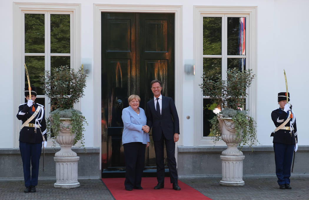 Dutch Prime Minister Mark Rutte, right, poses with German Chancellor Angela Merkel, at the entr ...