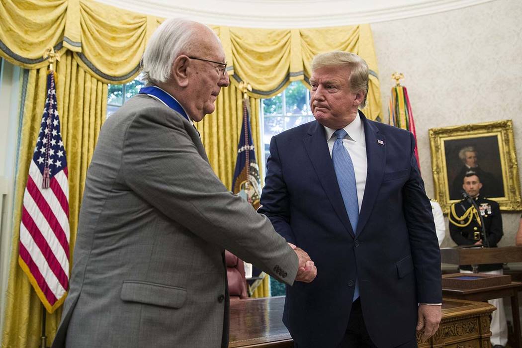 President Donald Trump shakes hands during a Presidential Medal of Freedom ceremony for former ...