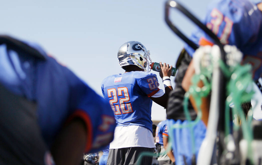 Bishop Gorman's linebacker Hudson Benjamin (22) hydrates during practice at Bishop Gorman High ...