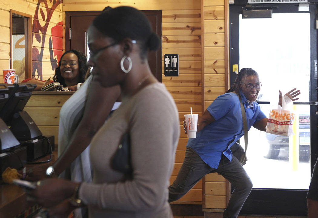 Kimberly Taylor poses after receiving her chicken sandwich at Popeyes on the corner of Bonanza ...