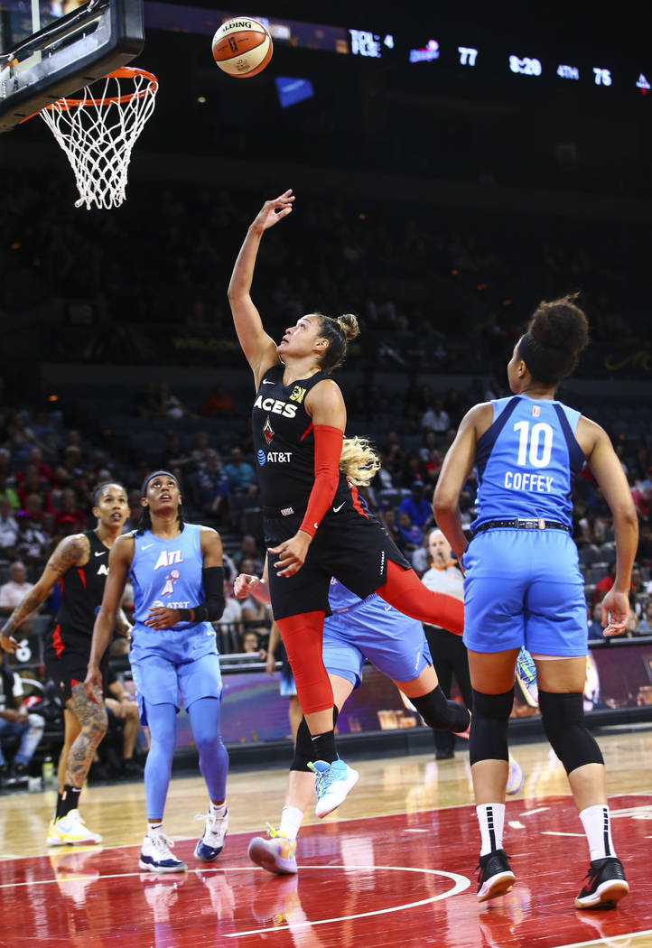 Las Vegas Aces' Kayla McBride goes to the basket in front of Atlanta Dream's Nia Coffey (10) du ...
