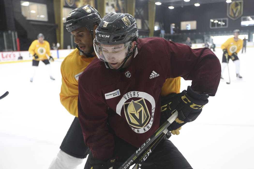 Vegas Golden Knights center Cody Glass (8), foreground, and right wing Ryan Reaves take part in ...