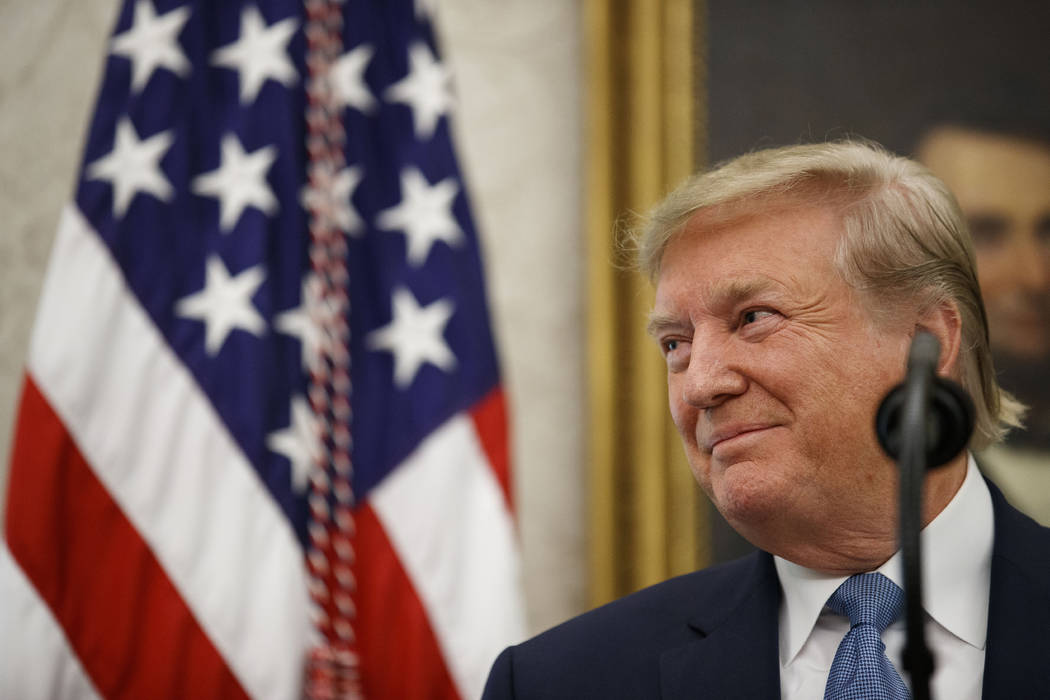 President Donald Trump smiles while speaking during a Presidential Medal of Freedom ceremony fo ...