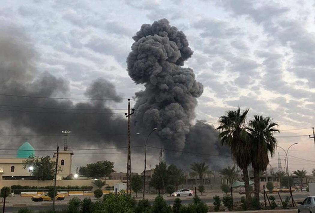 A Monday, Aug. 12, 2019, photo shows plumes of smoke rising after an explosion at a military ba ...