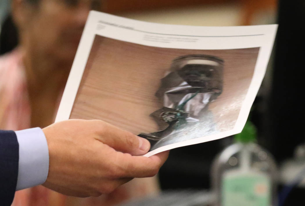 Prosecutor Christopher Pandelis holds a photograph of a homemade explosive device on Wednesday, ...