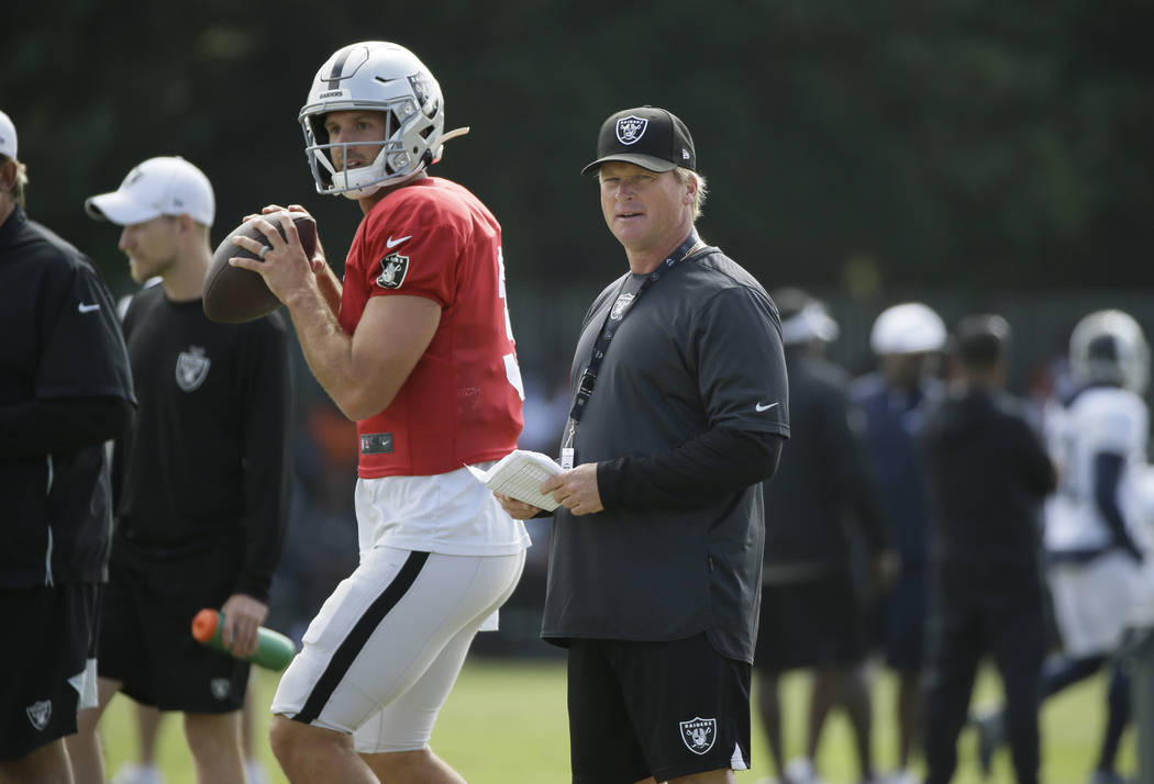 Oakland Raiders head coach Jon Gruden watches quarterback Nathan Peterman during NFL football t ...