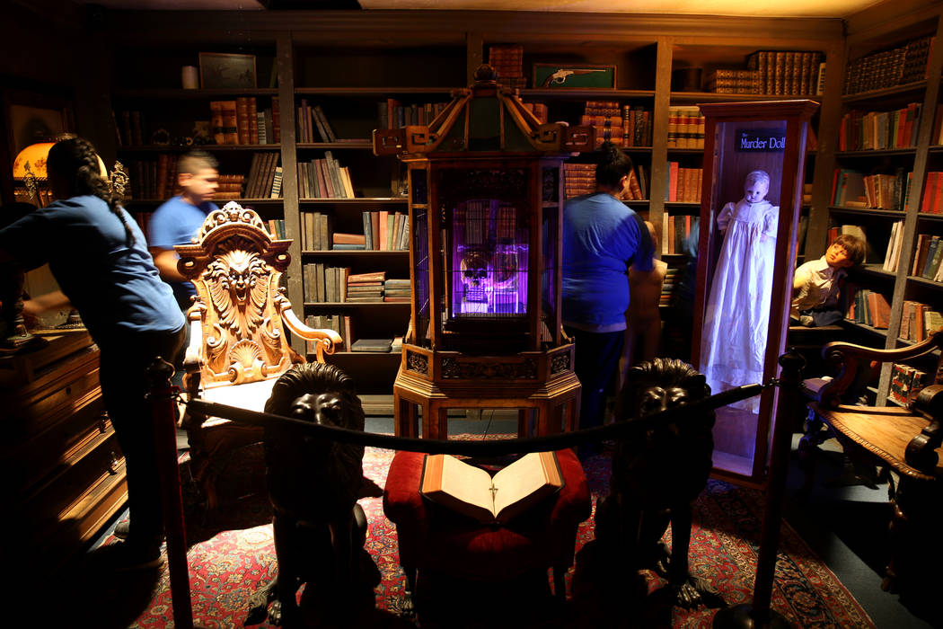 Clean Tastic workers do custodial work in the Library Room at Zak Bagans' Haunted Museum in dow ...