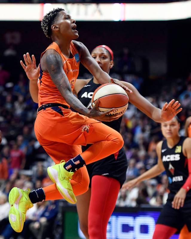 Connecticut Sun guard Courtney Williams puts up her shot as she is fouled by Las Vegas Aces for ...
