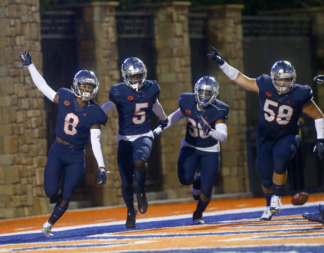 Bishop Gorman's Fabian Ross (8) celebrates his touchdown with teammates during the first half o ...