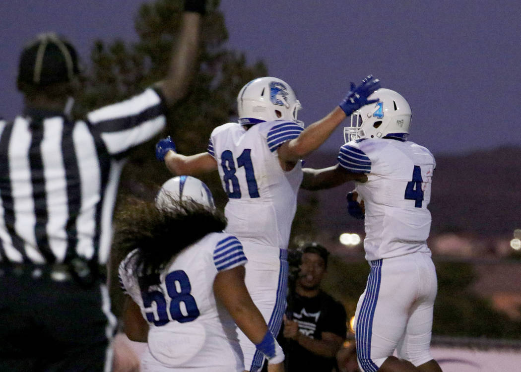 Chandler, Ariz., High's Dae Dae Hunter (4) celebrates his touchdown with his teammates Jay McEu ...