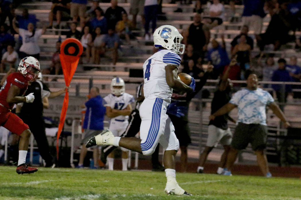 Chandler, Ariz., High's Dae Dae Hunter runs to a touchdown during the first half of their game ...