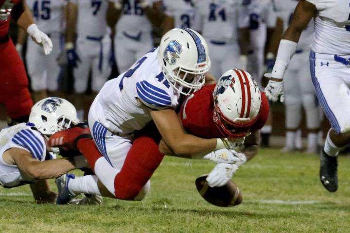 Liberty High's Edward Gastelum (4) fumbles after being tackled by Chandler, Ariz., High's Kyler ...