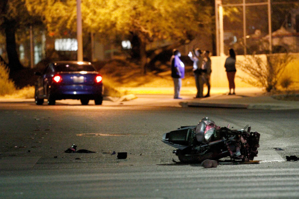 Las Vegas police officers investigate a fatal motorcycle crash at Martin Luther King Boulevard ...