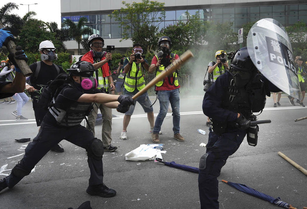 Police and demonstrators clash during a protest in Hong Kong, Saturday, Aug. 24, 2019. Chinese ...