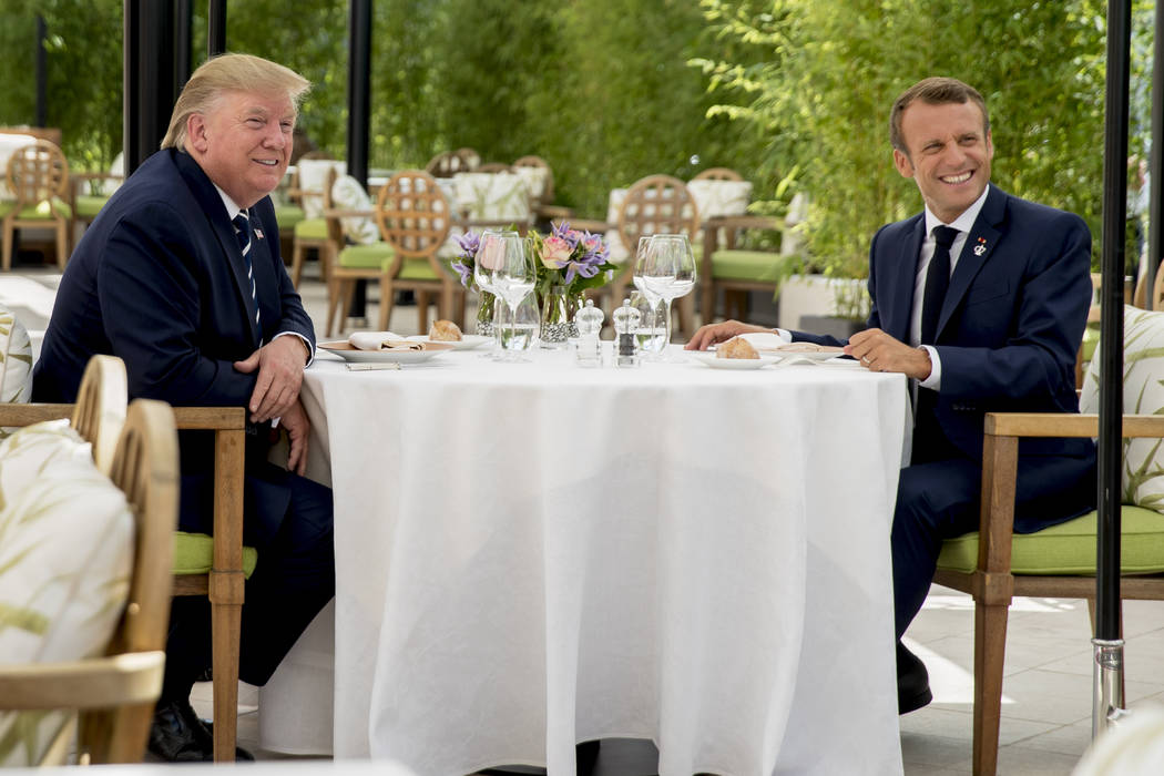 U.S President Donald Trump sits for lunch with French President Emmanuel Macron, right, at the ...