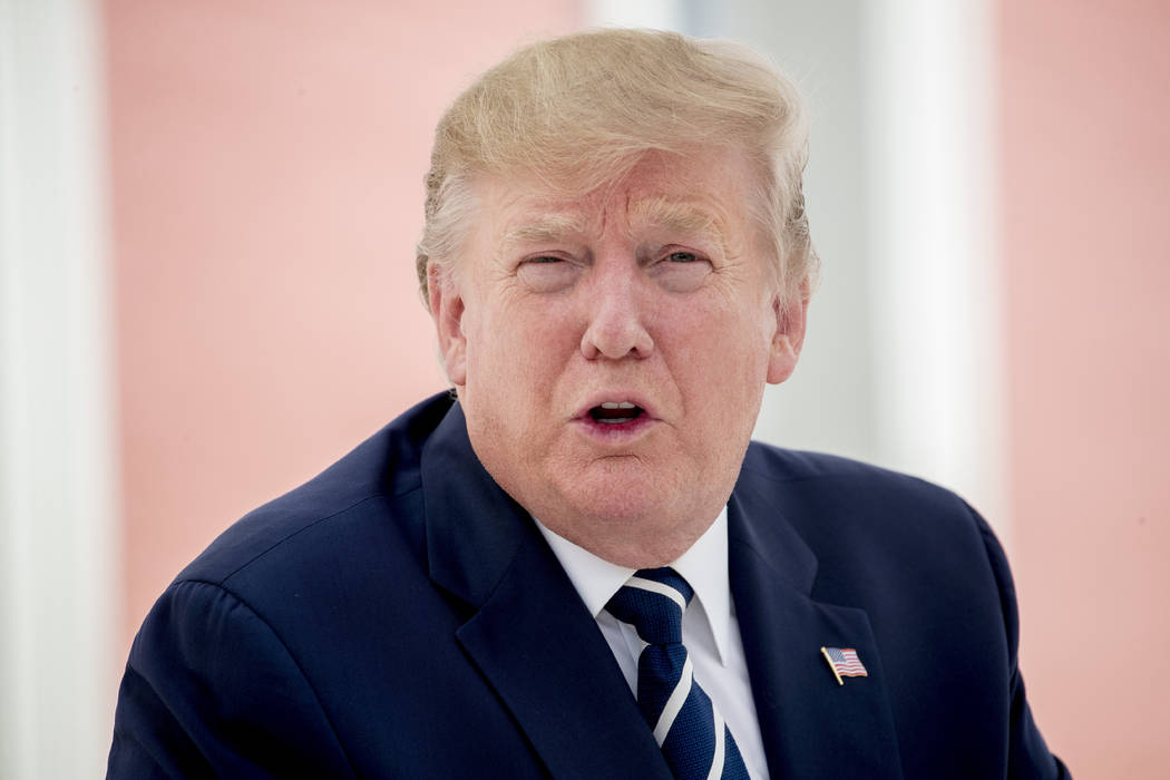 U.S President Donald Trump talks to the media as he sits for lunch with French President Emmanu ...