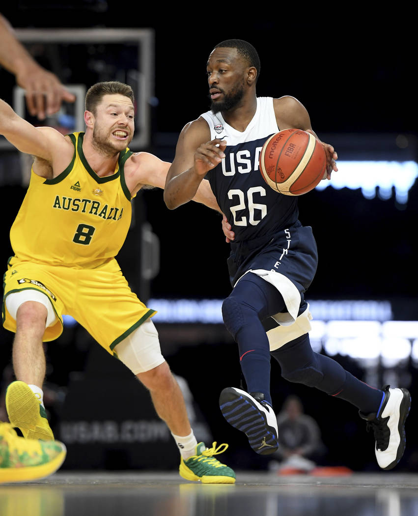 Australia's Matthew Dellavedova, left, and United States' Kemba Walker in action during their e ...