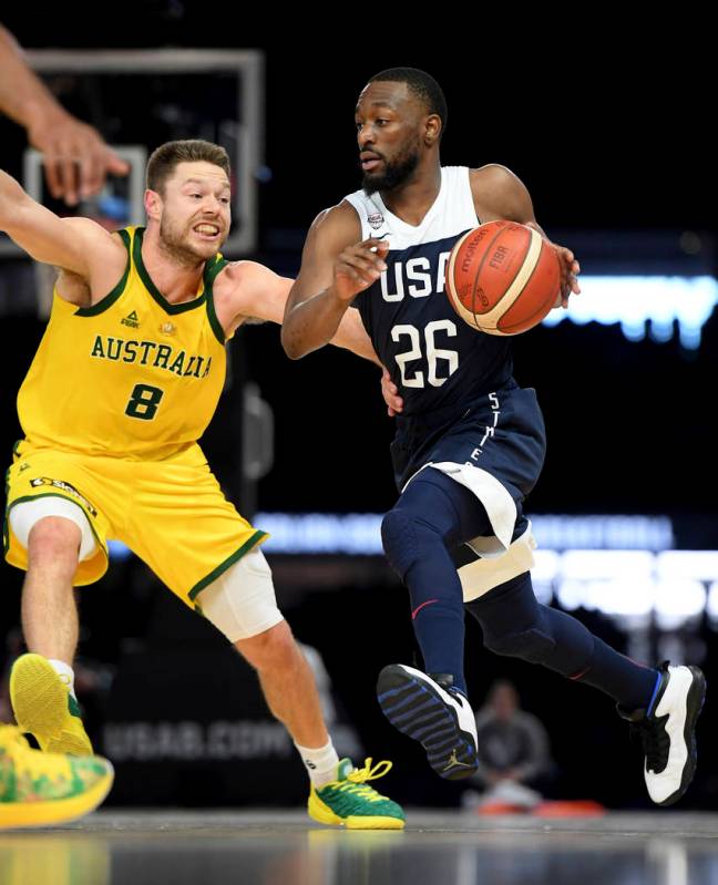 Australia's Matthew Dellavedova, left, and United States' Kemba Walker in action during their e ...