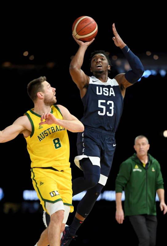 United States' Donovan Mitchell, right, attempts a basket against Australia's Matthew Dellavedo ...