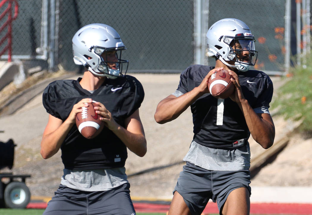 UNLV Rebels quarterbacks Kenyon Oblad, left, (7) and Armani Rogers (1) prepare to throw balls d ...