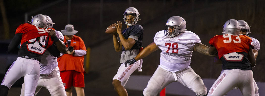 Offensive lineman Justin Polu (78, right center) helps to defend quarterback Armani Rogers (1, ...