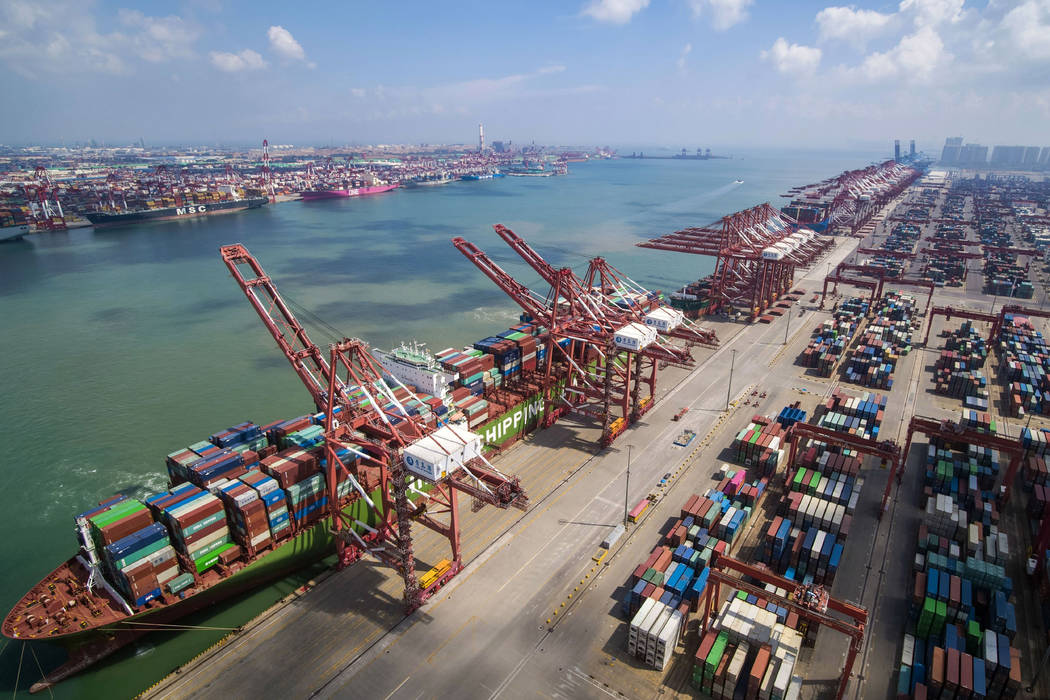 In this Aug. 6, 2019, photo, a container ship is docked a port in Qingdao in eastern China's Sh ...